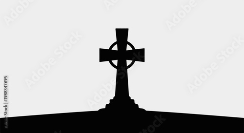 Silhouette of a Celtic cross monument against a light sky