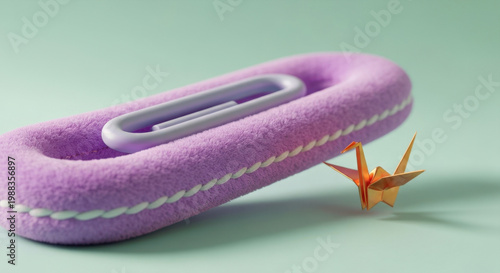 Colossal Soft Chenille Paperclip Gently Clips Tiny Iridescent Origami Crane in Surreal Macro Close-up