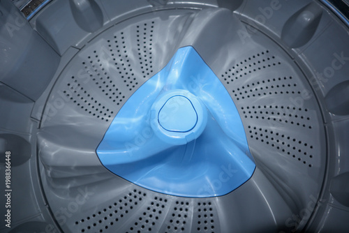 Obraz na plátně Top view close up of a gray and blue washing machine pulsator plate