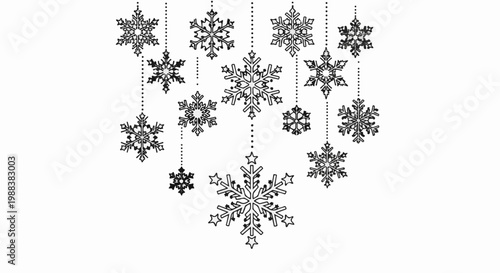 Multiple intricate snowflakes in varying sizes hang suspended by dotted lines on white