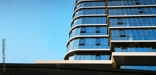 Multi-storey eco-friendly house. Glass facades, economical housing. Minimalist architectural background with blue sky copy space