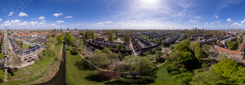 Cityscape 180 degrees aerial of residential neighbourhood Watergraafsmeer in Amsterdam, The Netherlands with Hofkerk church square in the middle of the low housing quadrant. Dutch housing real estate 