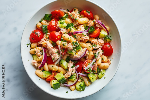high protein tuna and white bean salad fully mixed in a white ceramic bowl