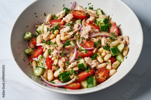 high protein tuna and white bean salad fully mixed in a white ceramic bowl