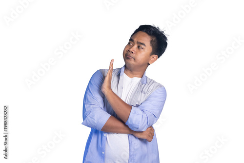Photos Disapproving Asian man making stop gesture, looking sideways