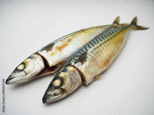 Close-up of two whole cooked trout with herbs and lemon slices whole fish