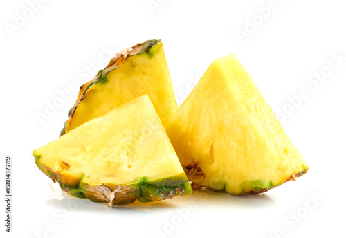 Fresh pineapple slices with green rind and yellow flesh on white background
