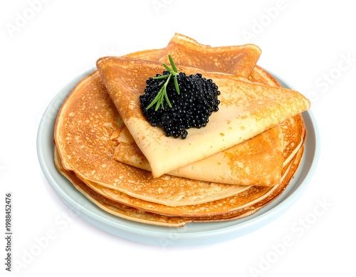 Golden pancakes artfully stacked on a light blue plate, topped with a generous serving of black caviar and a sprig of rosemary. The white backdrop enhances the food's presentation