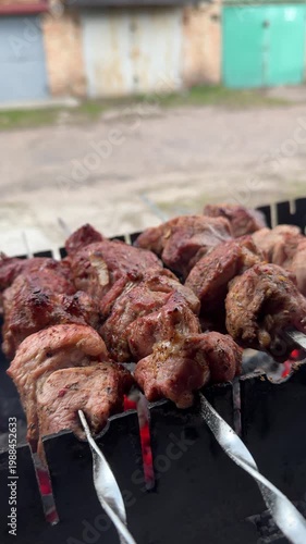 Grilling shashlik on charcoal barbecue