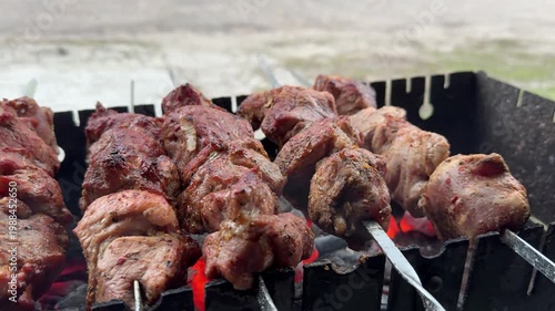 Grilling shashlik on charcoal barbecue