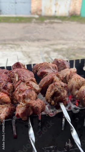 Grilling shashlik on charcoal barbecue
