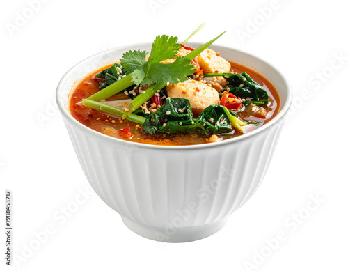 Chili lime soup with greens and dumplings in a white bowl
