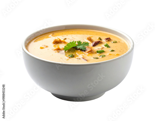 Chilled creamy soup with garnish and herbs, smooth texture in white bowl