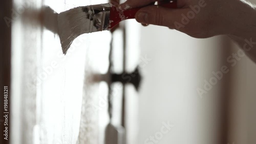 Close-up of Man Painting Old Wooden Door with Brush, Detailed Wood Restoration and Renovation, 4K 10-bit