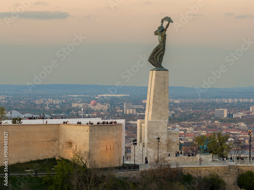 Renovated Liberty Statue, Szabadság Szobor, Citadella visitor center and Hungarian flag on Gellért Hill in Budapest, Hungary.