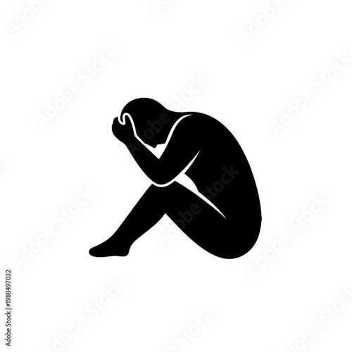 Silhouette of a person in despair head in hands.