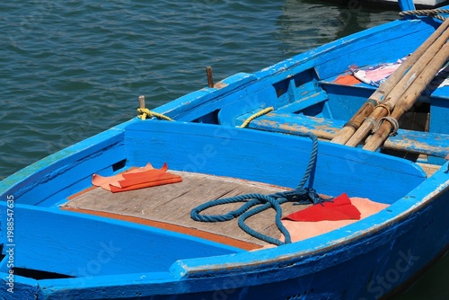 Obraz na płótnie Blue traditional fishing boat in Mediterranean harbor of Bari, Italy