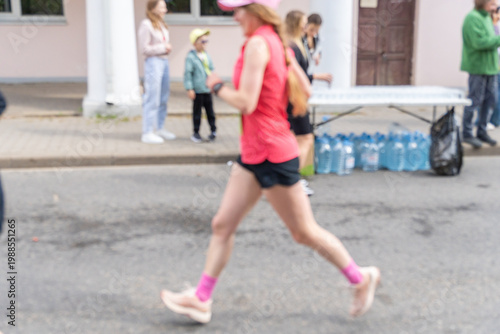 Wallpaper Mural Blurred motion of a female runner in red sportswear during an outdoor race. Torontodigital.ca