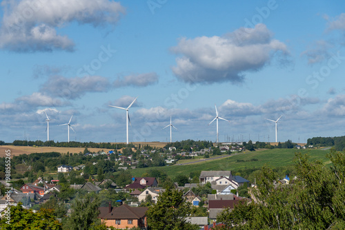 Wallpaper Mural Scenic landscape of a rural village with modern wind turbines on a hill Torontodigital.ca