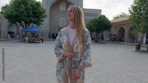 Woman in Uzbek traditional robe in Hazrati Imam Complex Tashkent yard