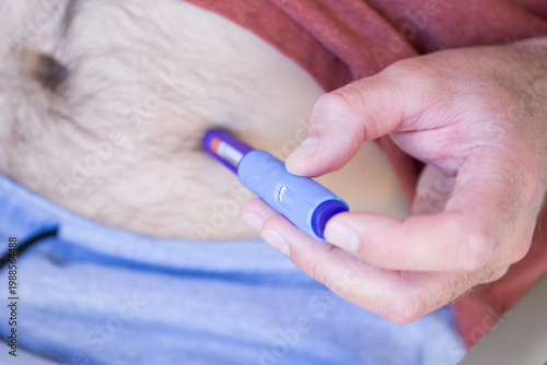 Photos man performing a subcutaneous medical injection using a blue injector pen Ozempi