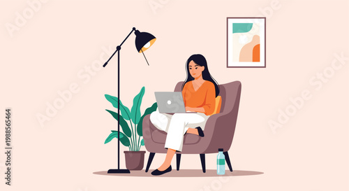Relaxed woman sits in a cozy armchair and works on her laptop with a bottle of water and plant nearby.