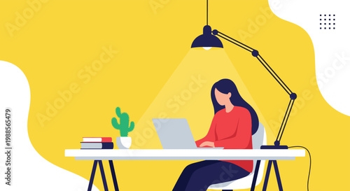 Professional woman works late at her desk using a laptop under the light of a desk lamp in a yellow room.