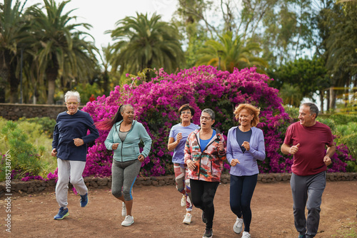 Happy elderly people doing running exercise at city park - Multiracial senior group, healthy lifestyle and sport concept