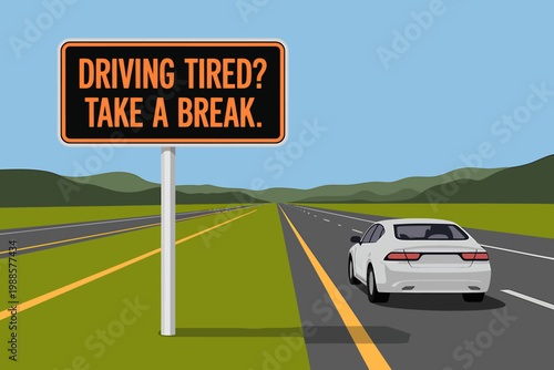 A white car drives along an empty highway next to a sign warning about driving tired