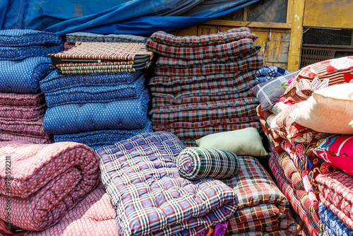 Colorful mattresses and cushions for sale at a market in the streets of Old Delhi, India, Asia