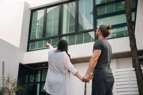 Fotografie Father's Day Concept, couple viewing modern house exterior real estate home arch