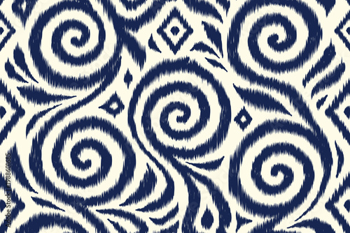 Seamless ikat pattern with hand drawn spiral ethnic ornament in indigo blue and cream background, traditional tribal textile surface design.