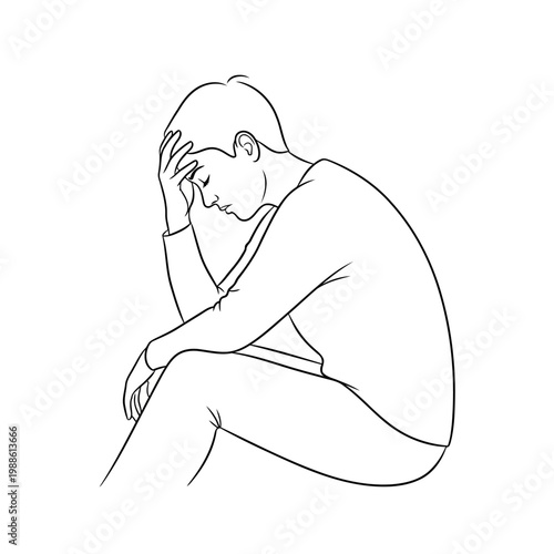 A man sits in a state of distress and frustration on the floor