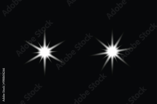 Two bright starbursts shine against a black background