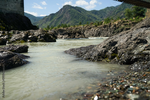 a high green mountain near the river bank