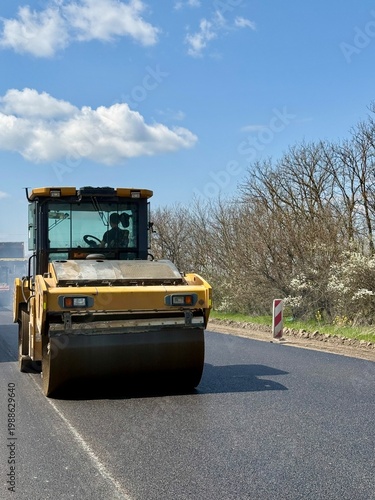 Roadwork road roller at hot asphalt