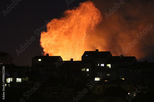 Huge fire and subsequent explosion in a residential neighborhood at night. House fire. Huge fire that destroyed a house