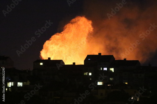 Huge fire and subsequent explosion in a residential neighborhood at night. House fire. Huge fire that destroyed a house