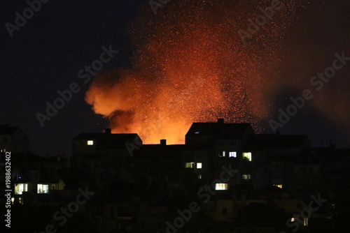 Huge fire and subsequent explosion in a residential neighborhood at night. House fire. Huge fire that destroyed a house