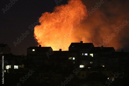 Huge fire and subsequent explosion in a residential neighborhood at night. House fire. Huge fire that destroyed a house