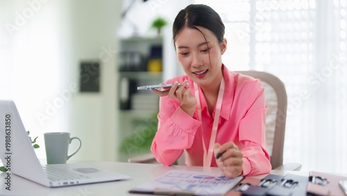 Photography Focused Work: A focused business woman works in home, immersed in her task, the glow of the screen illuminating her determined expression