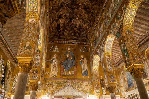 Byzantine mosaics and frescoes adorning the ornate golden interior of Monreale Cathedral in Sicily, Italy. Stunning medieval religious iconography with intricate geometric patterns and sacred imagery.