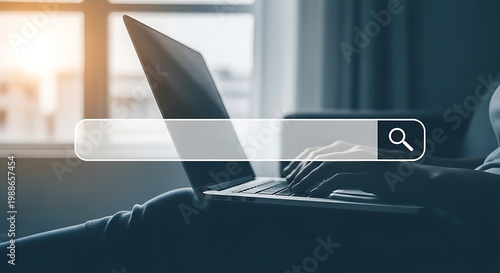 Person using laptop with search bar on screen for online browsing
