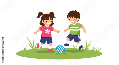 Two happy young children a boy and a girl playing soccer together on a patch of green grass in a public park area.