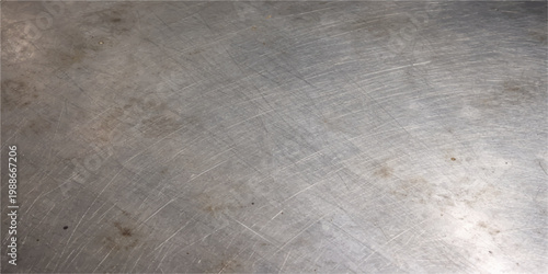 Scratched steel texture background with circular abrasion marks, worn metallic surface, industrial grunge pattern, dirty rough metal backdrop, abstract distressed design