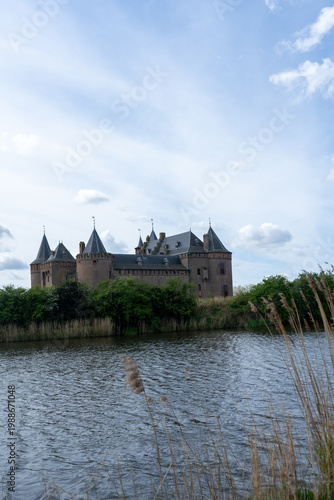 Bild auf Leinwand Muiderslot castle in Muiden, the Netherlands, viewed from a distance across the water on a clear day