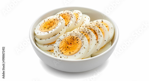 Sliced Boiled Eggs with Black Pepper in Bowl Isolated on White