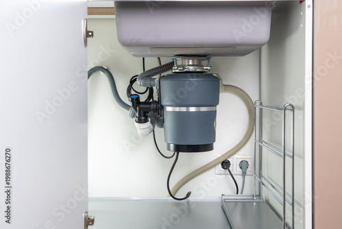Quadro su tela Garbage Disposal under the modern sink, waste chopper concept