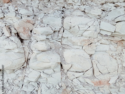 Natural texture of fractured white marl and limestone rock surface