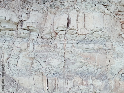 Natural texture of fractured white marl and sedimentary limestone rock.